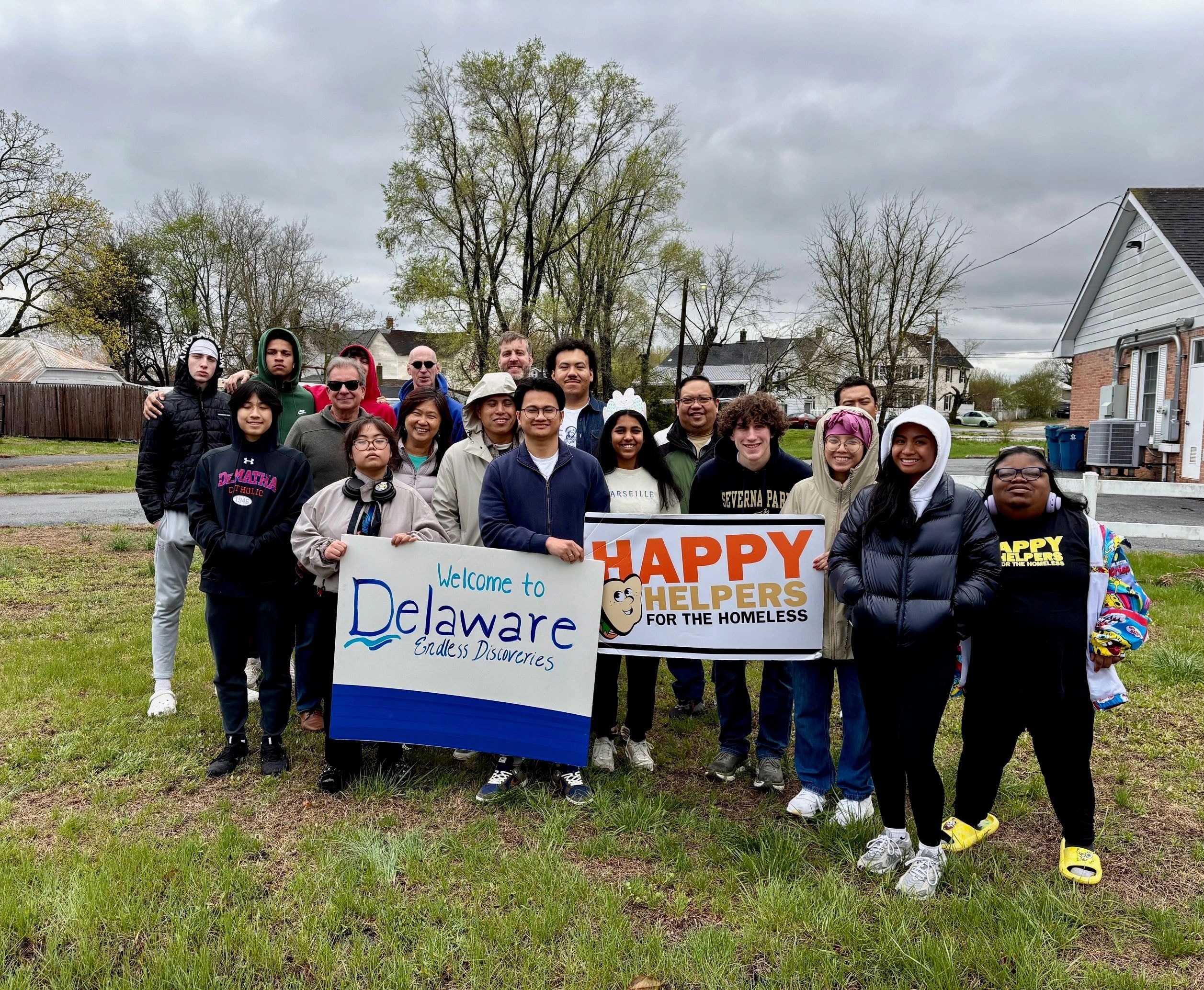 Volunteers with Happy Helpers for the Homeless banner